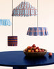 Nobodinoz lampenkappen Margot, Nicole en Blue Stripes boven een blauwe tafel